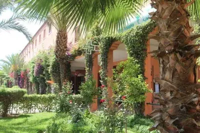 a building with a lot of plants and trees at résidence qarya syahia private roof terrasse in Marrakech