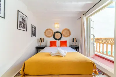 a bedroom with a large yellow bed with orange pillows at Riad Kasbabouch - Breakfast - 10mn to Jamaa Al Fna in Marrakech