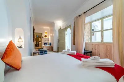 a bedroom with a large white bed and a window at Riad Kasbabouch - Breakfast - 10mn to Jamaa Al Fna in Marrakech