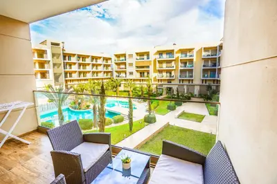 an apartment balcony with a view of a pool at Apartment pool marrakech in Marrakech