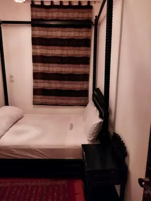 a small room with a bed and a window at Kesh apartment in Marrakech