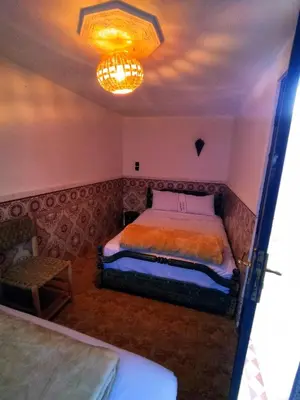 a bedroom with a bed and a chandelier at Kesh apartment in Marrakech