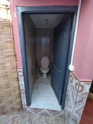 a bathroom with a toilet in a doorway at Kesh apartment in Marrakech