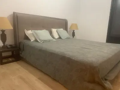 a bedroom with a large bed with pillows and two lamps at Family apart in Marrakech
