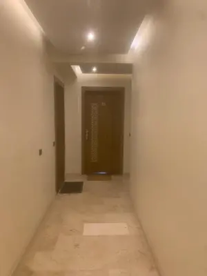 an empty hallway with a door in a room at Family apart in Marrakech