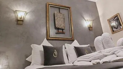 a bedroom with a bed with a picture on the wall at Riad Al Nubala in Marrakech