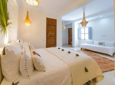 a bedroom with a large white bed with pillows at RIAD 48 & SPA in Marrakech