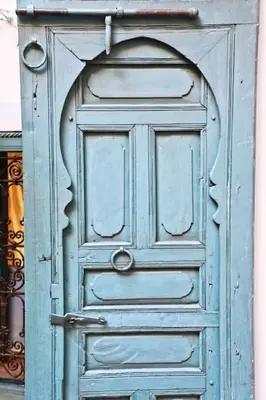 an old blue door with an archway on a building at Riad Dar Zitouna Marrakesh - entire house in exclusivity in Marrakech