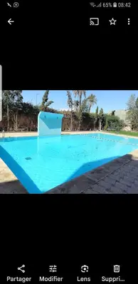 a picture of a large blue swimming pool at un moderne chic appartement vue sur piscine in Marrakech