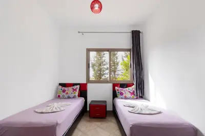 two beds in a room with a window at lafamilia in Marrakech