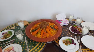a table with a bowl of food and plates of food at Riad dar Karam in Marrakech