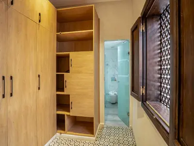 a bathroom with wooden cabinets and a toilet at MAISON SOLANEOS in Marrakech