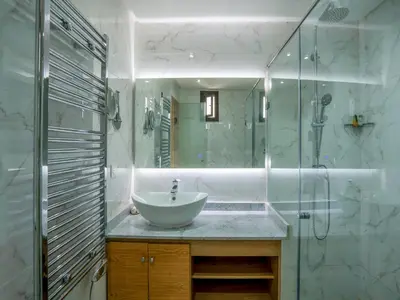 a bathroom with a sink and a glass shower at MAISON SOLANEOS in Marrakech