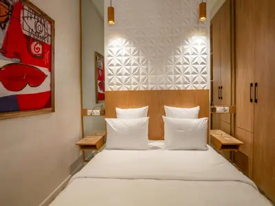 a bedroom with a large bed with white pillows at MAISON SOLANEOS in Marrakech