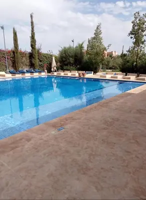 a large swimming pool with blue water at Pavillon Affaoui Golf & Waky in Marrakech
