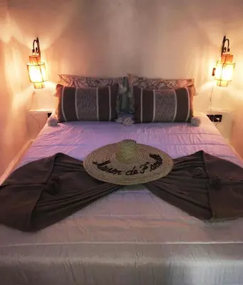 a bed with a sign on top of it at Maison ALPHEA SPA HAMMAM in Marrakech