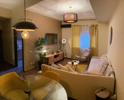 a living room with a couch and a table at Appartment Zaina in Marrakech