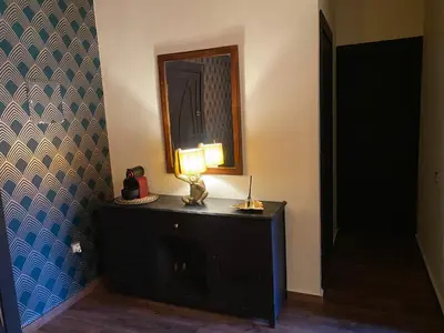 a lamp on a dresser in a room with a mirror at Appartment Zaina in Marrakech