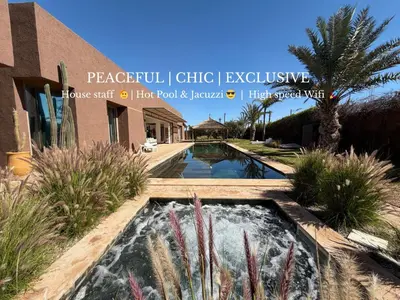 a swimming pool in front of a building at Villa Zen'O Palmeraie - Hot Pool in Marrakech