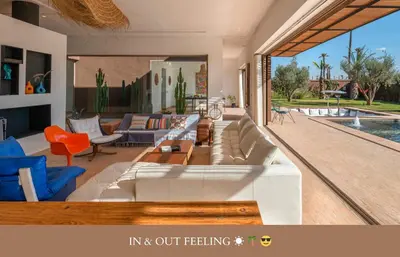 a living room with a couch and chairs and a pool at Villa Zen'O Palmeraie - Hot Pool in Marrakech