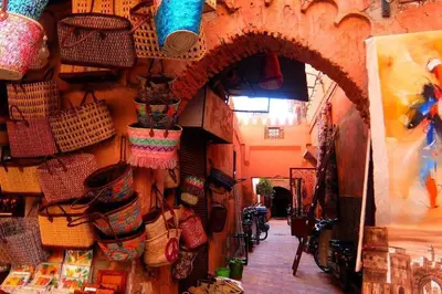 an alley with baskets on the wall of a store at Sunset Marrakech in Marrakech