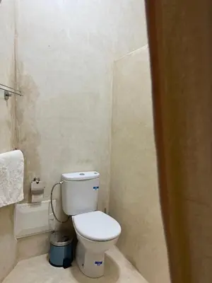 a small bathroom with a toilet and a shower at Riad Dar Les Freres in Marrakech