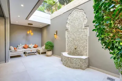 a room with a bathtub in the middle of a building at Villa Simeon Marrakech in Marrakech