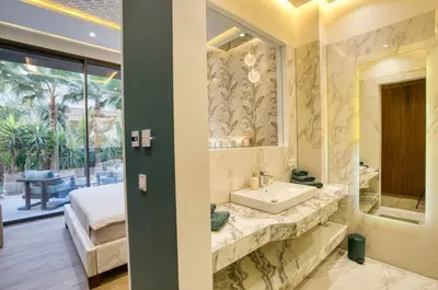 a bathroom with a sink and a large mirror at Villa Simeon Marrakech in Marrakech