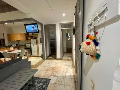 a room with a kitchen and a living room at Au Cœur de la Palmeraie de Marrakech in Marrakech
