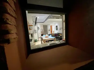 a view of a living room through a window at Au Cœur de la Palmeraie de Marrakech in Marrakech