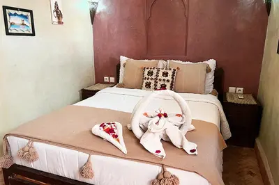 a bedroom with a bed with towels on it at Dar Ben Saleh in Marrakech