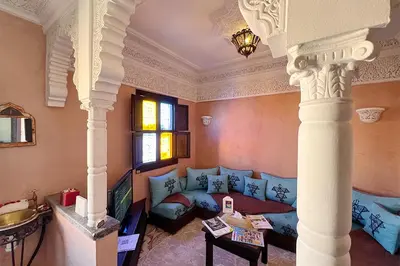 a living room with a blue couch in a room at Dar Ben Saleh in Marrakech