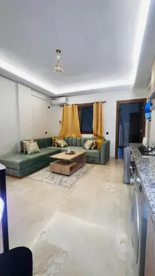 a living room with a couch and a table at Luxury apartment Gueliz (2 min walk from Train Station) in Marrakech