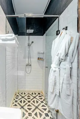 a bathroom with a shower with white towels at Yanis Guest House in Marrakech