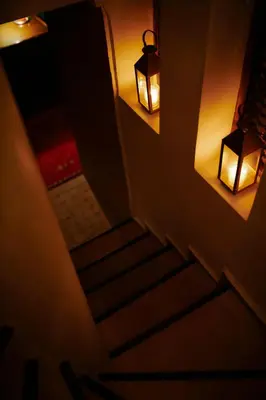 a stairway with two lights and two lights on the wall at Riad Alena in Marrakech