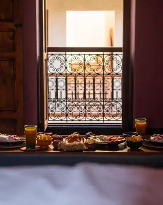 a table topped with plates of food and drinks at Riad Alena in Marrakech