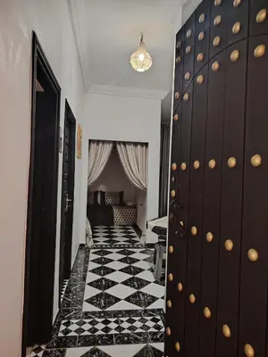 a hallway with a black and white tiled floor at Appartement résidence avec piscine in Marrakech