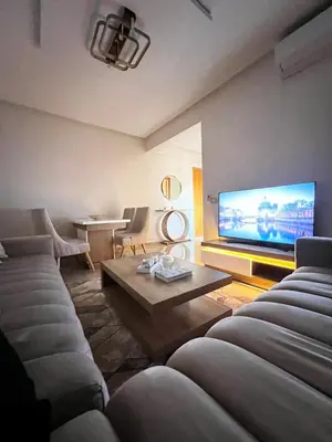 a living room with two couches and a flat screen tv at Arras operah marrakech in Marrakech