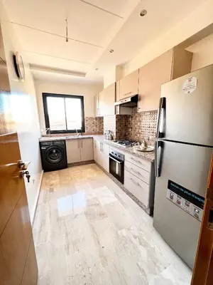 a kitchen with a refrigerator and a dishwasher at Arras operah marrakech in Marrakech