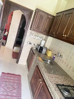 a kitchen with a sink and a mirror at Flair's - Families Only in Marrakech