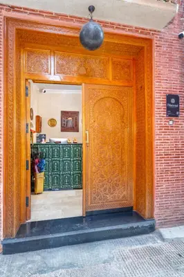 an entrance to a building with a wooden door at Riad Diamond Of Marrakech & Spa in Marrakech