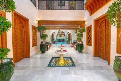 a lobby with a fountain in the middle of a building at Riad Diamond Of Marrakech & Spa in Marrakech