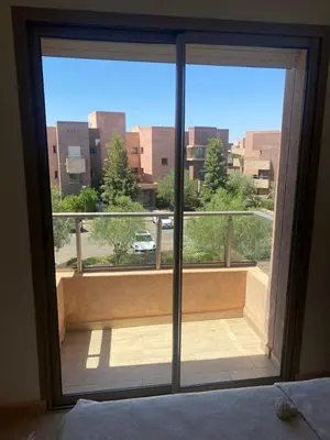 a large window with a view of a balcony at Prestigia jade Marrakech ENTREE 191 APPARTEMENT 9 in Marrakech