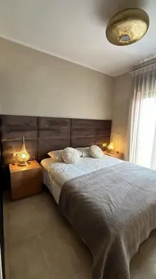 a bedroom with a large bed with two night stands at Magnifique villa avec piscine chauffée in Marrakech