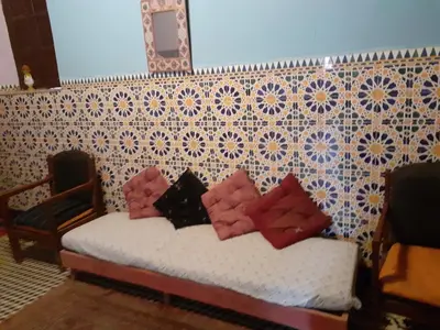 a bed with four pillows on it in a room at Maison authentique centre médina in Marrakech