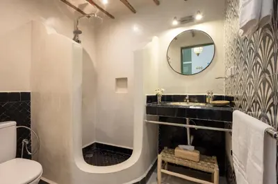a bathroom with a sink and a mirror at Riad Espoir Spa Logement entier in Marrakech
