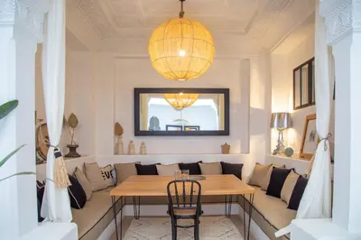 a dining room with a table and a chandelier at RIAD DAR C in Marrakech