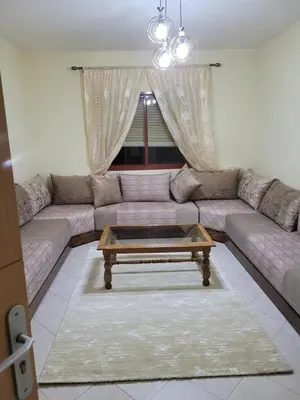 a living room with a couch and a coffee table at Basic appartement avec Parking in Marrakech