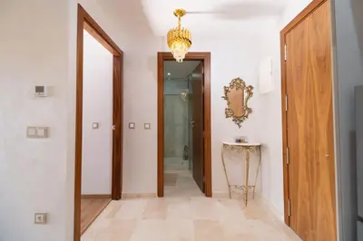 a hallway with a door and a chandelier at pearl garden marrakech in Marrakech