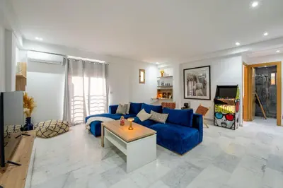 a living room with a blue couch and a table at NEW ! Unique Equipped Flat in the Heart of Marrakech in Marrakech